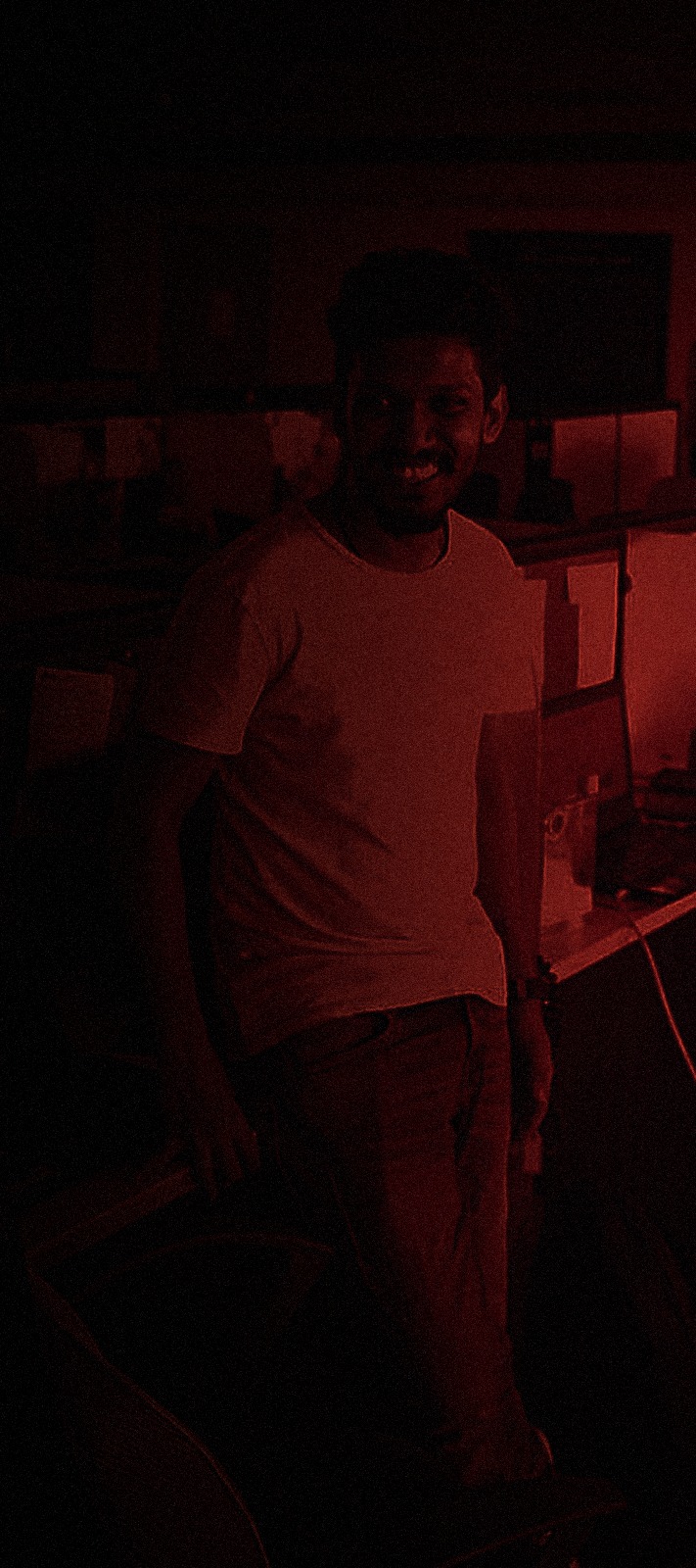 Portrait of Sahil Gohel, cinematic red-lit lighting